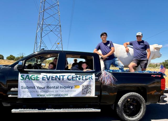 The SAGE Center Team smiling from their 4th of July parade truck. 