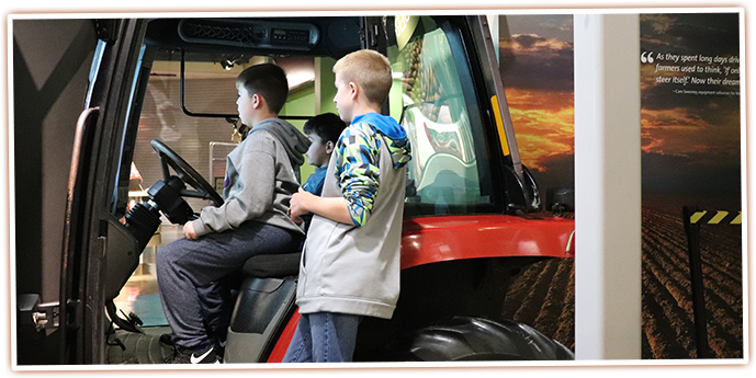 Visitors try their hand at driving a tractor at this interactive exhibit at the SAGE Center