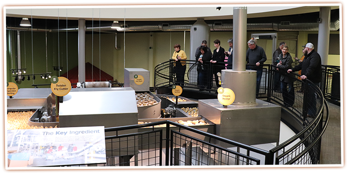 Observe the kinetic sculpture and see how potatoes are turned into french fries